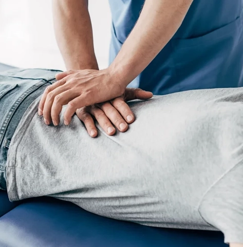 A chiropractor giving a back adjustment.