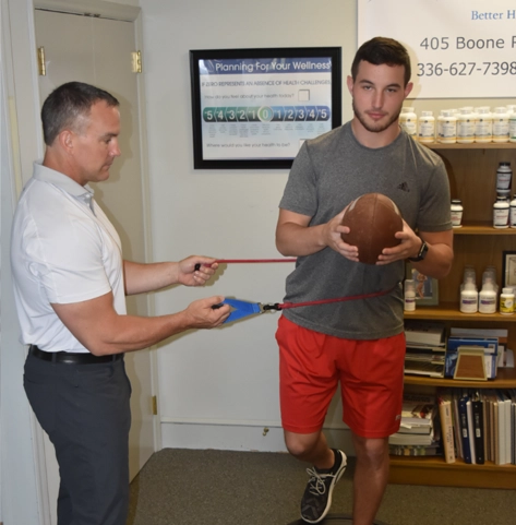 John Dabbs with a sports injury patient.